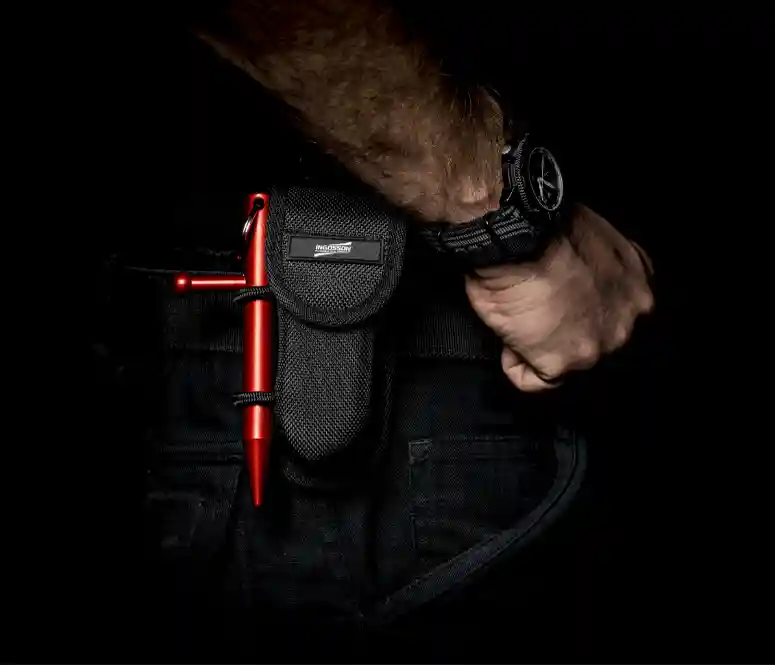 a red Kubotee self defence tool in a holster