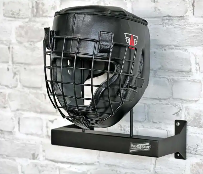 black headgear rack bolted to a brick wall
